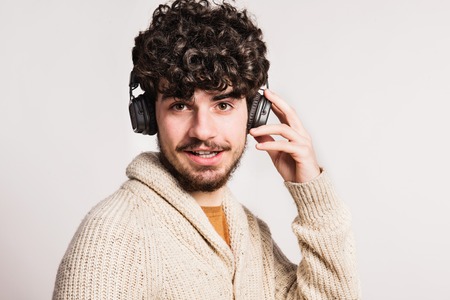 Portrait of a young man with headphones in a studio.の写真素材