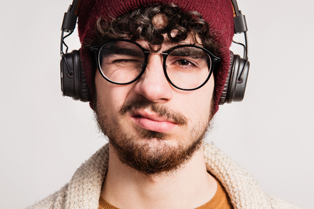 Portrait of a young man with headphones in a studio.の写真素材