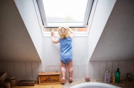Toddler boy in a dangerous situation at home.の写真素材