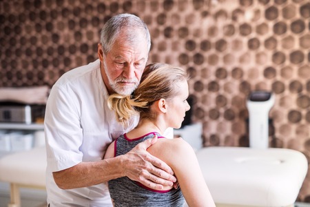 Senior physiotherapist working with a female patient.の写真素材