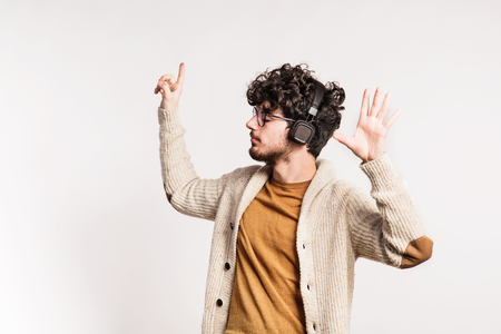 Portrait of a young man with headphones in a studio.の写真素材