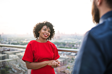 Two businesspeople standing against London view panorama, talking.の写真素材