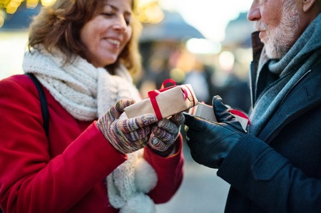 Senior couple on an outdoor Christmas market.の写真素材