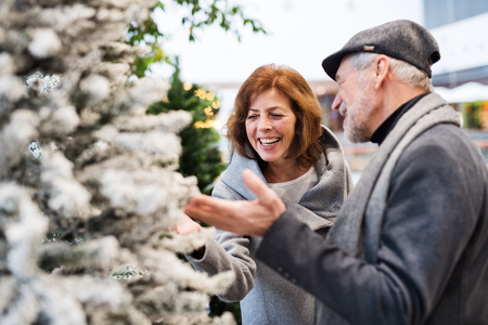 Happy senior couple doing Christmas shopping together.の写真素材