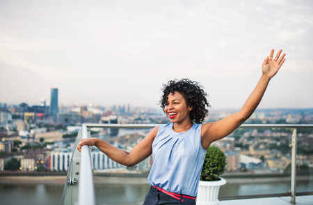 A portrait of businesswoman standing against London rooftop view panorama.の写真素材
