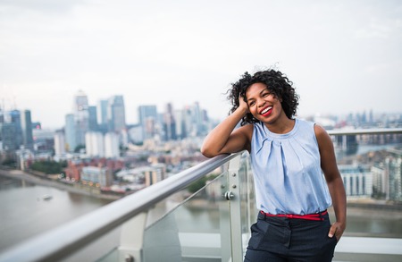 A portrait of a woman standing on a terrace in London. Copy space.の写真素材