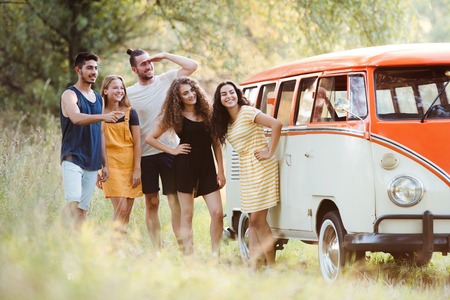 A group of young friends on a roadtrip through countryside.の写真素材