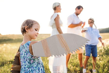 Young family with small children playing on a meadow in nature.の写真素材
