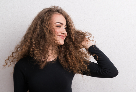Young beautiful happy woman standing in studio.
