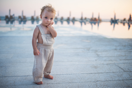 A small toddler girl standing on beach on summer holiday. Copy space.の写真素材