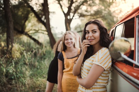 A group of young girl friends on a roadtrip through countryside.の写真素材