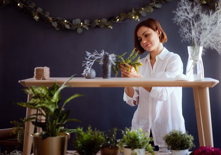 Young creative woman in a flower shop. A startup of florist business.の写真素材