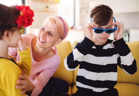 A young woman with two children having fun at home.の写真素材