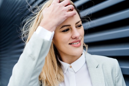 A close-up portrait of young businesswoman standing outdoors.の写真素材