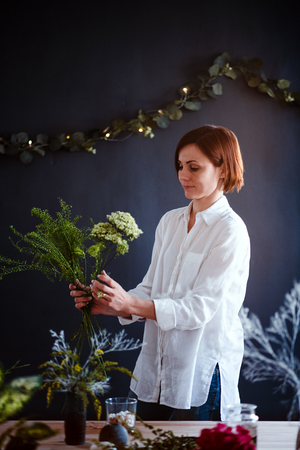 Young creative woman in a flower shop. A startup of florist business.の写真素材