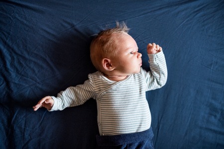 A close-up of a cute newborn baby at home.