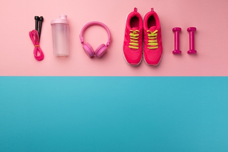 A studio shot of running shoes and other sport equipment on color background.の写真素材