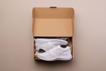 A studio shot of pair of running shoes in paper box. Flat lay.の写真素材