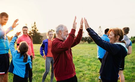 Large group of fit and active people resting after doing exercise in nature.の写真素材