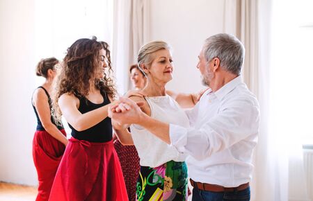 Group of senior people in dancing class with dance teacher.の写真素材