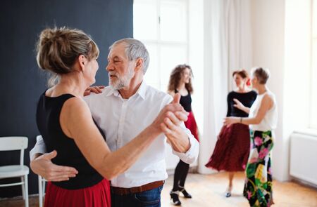 Group of senior people in dancing class with dance teacher.