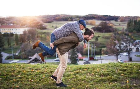 Senior father and his son walking in nature, having fun.