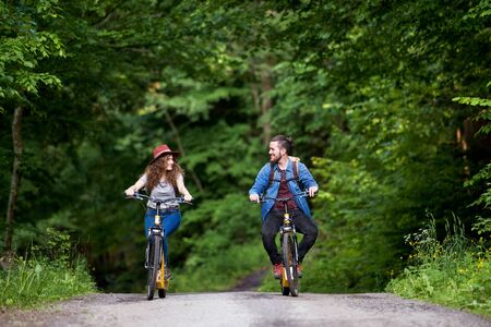 Young tourist couple travellers with electric scooters in nature.の写真素材