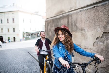 Young tourist couple travellers with electric scooters in small town.の写真素材