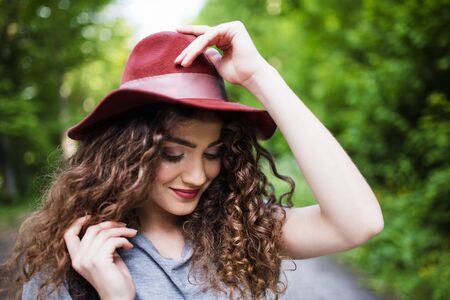 Close-up portrait of young woman traveller standing in nature.の写真素材