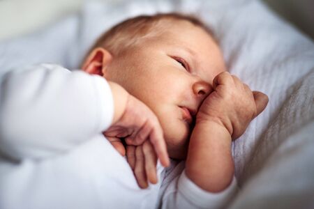 A close-up of a sleeping newborn baby at home.の写真素材