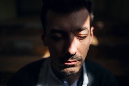 A portrait of young man indoors, a close-up.の写真素材