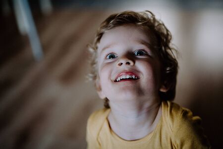 A top view of a toddler boy at home, looking up.の写真素材
