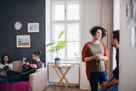 A group of young friends indoors at home, house sharing concept.の写真素材