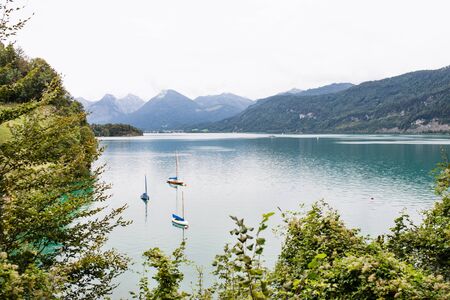 Boats on lake in the mountains, panoramic landscape.の写真素材