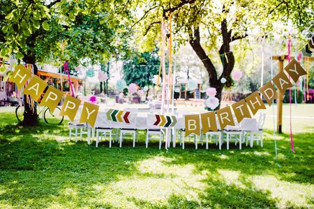 A table set for kids birthday party outdoors in garden in summer.の写真素材