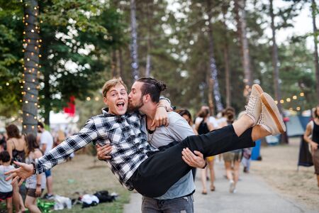 Two young men friends at summer festival, having fun.の写真素材