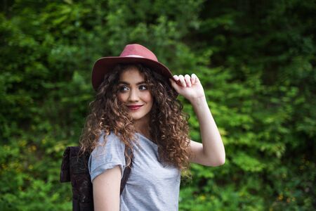 Young tourist woman traveller with backpack walking in nature.の写真素材