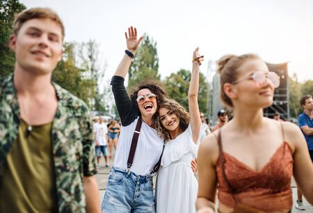 Front view portrait of group of young friends dancing at summer festival.の写真素材