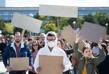 People with placards and protective suit on global strike for climate change.の写真素材