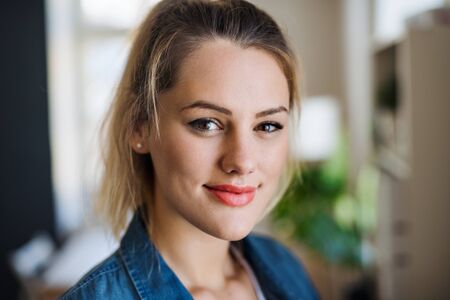 Close-up portrait of happy young woman indoors at home.