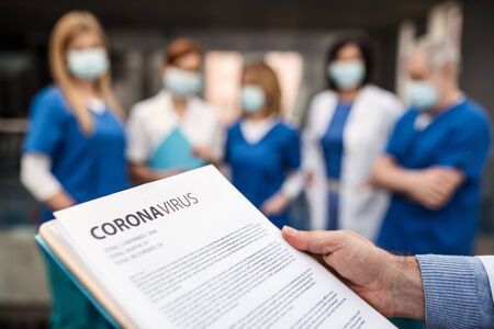 Group of doctors talking about corona virus on conference.の写真素材