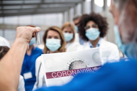 Group of doctors talking about corona virus on conference.の写真素材