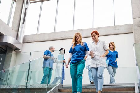 Group of doctors walking and talking, corona virus concept.の写真素材