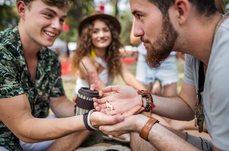 Group of young friends at summer festival, drug dealing concept.の写真素材