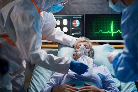 Infected patient in quarantine lying in bed in hospital, coronavirus concept.の写真素材