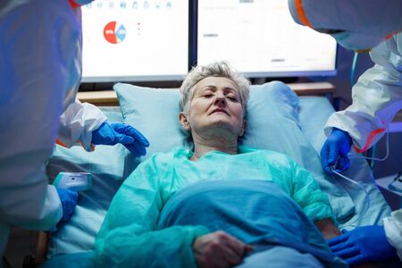 Infected patient in quarantine lying in bed in hospital, coronavirus concept.