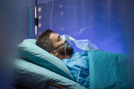 Infected patient in quarantine lying in bed in hospital, coronavirus concept.の写真素材