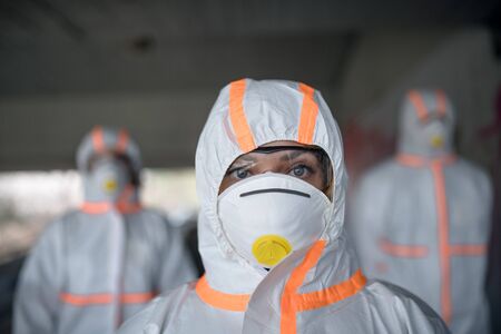 People with protective suits and respirators outdoors, coronavirus concept.の写真素材