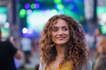 Portrait of young woman standing at summer festival.の写真素材