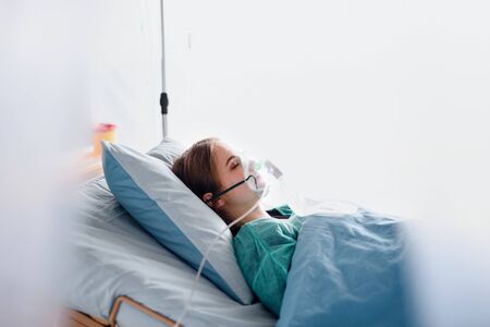 Infected patient in quarantine lying in bed in hospital, coronavirus concept.